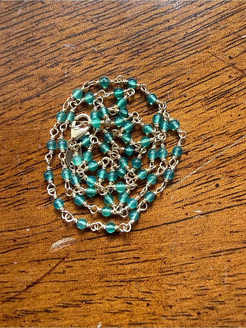 Delicate 14k yellow gold and green onyx station chain.